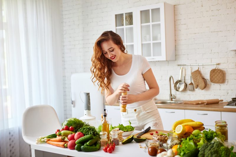 Young woman preparing summer detox salad