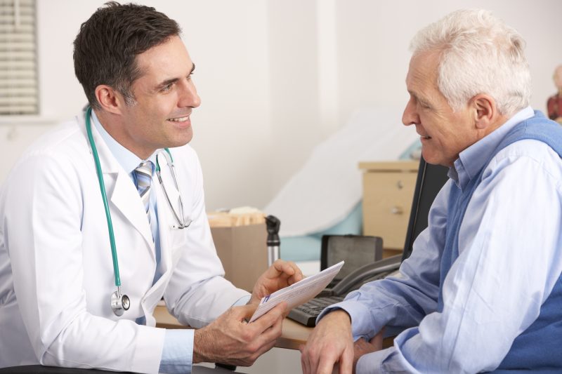 Doctor talking to senior man