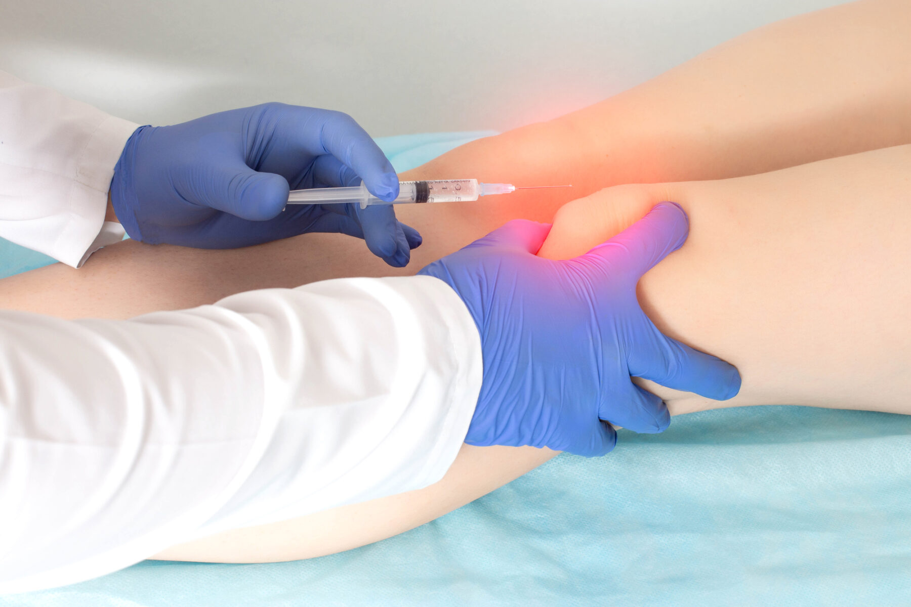 Doctor injecting stem cells into a knee