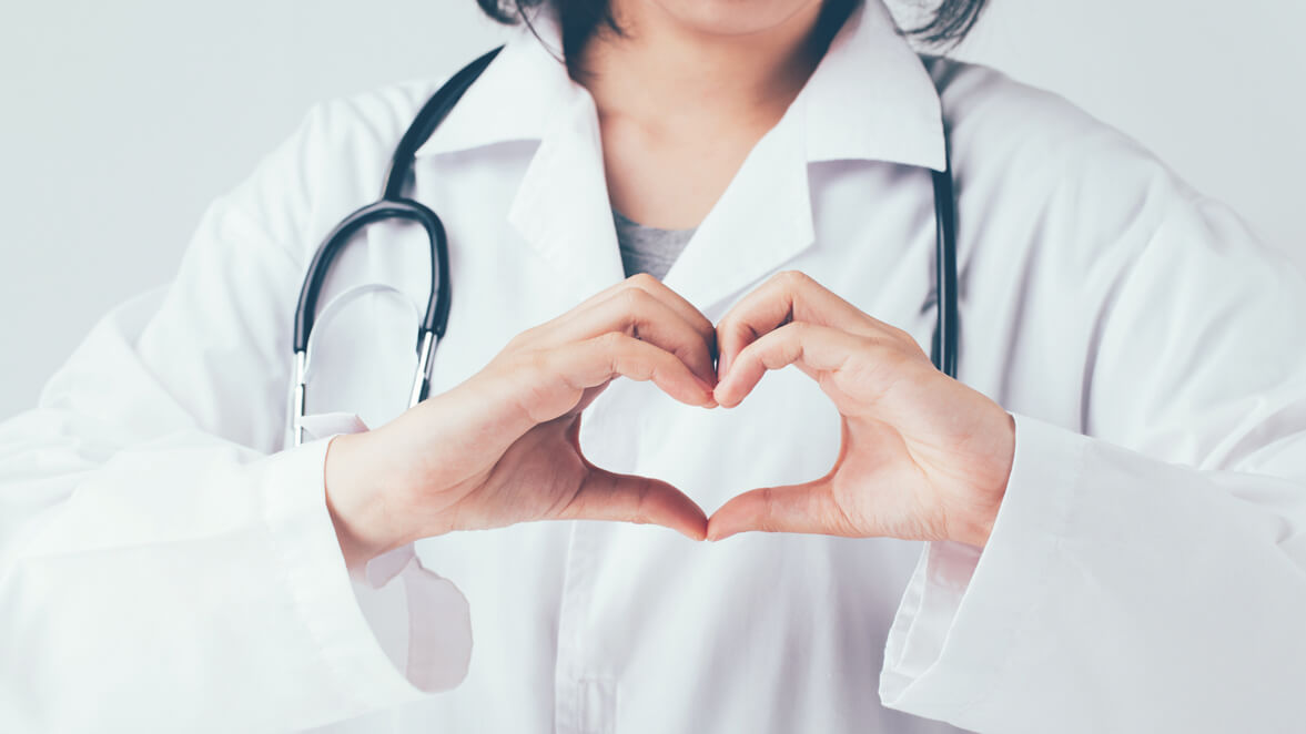 a doctor holding their hands into the shape of a heart