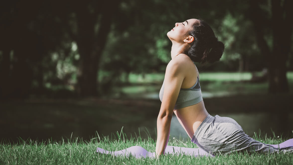 a woman doing yoga outdoors